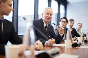A board member speaking into a microphone.