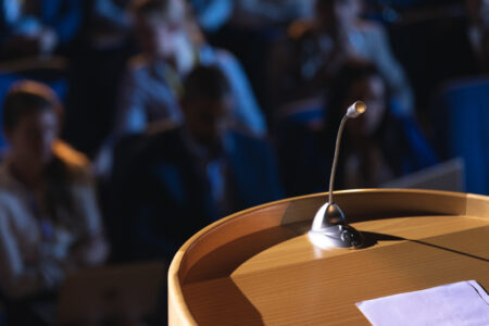 Podium with speaker in auditorium.