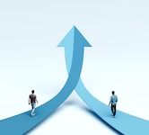 Two individuals walking along arrows that merge