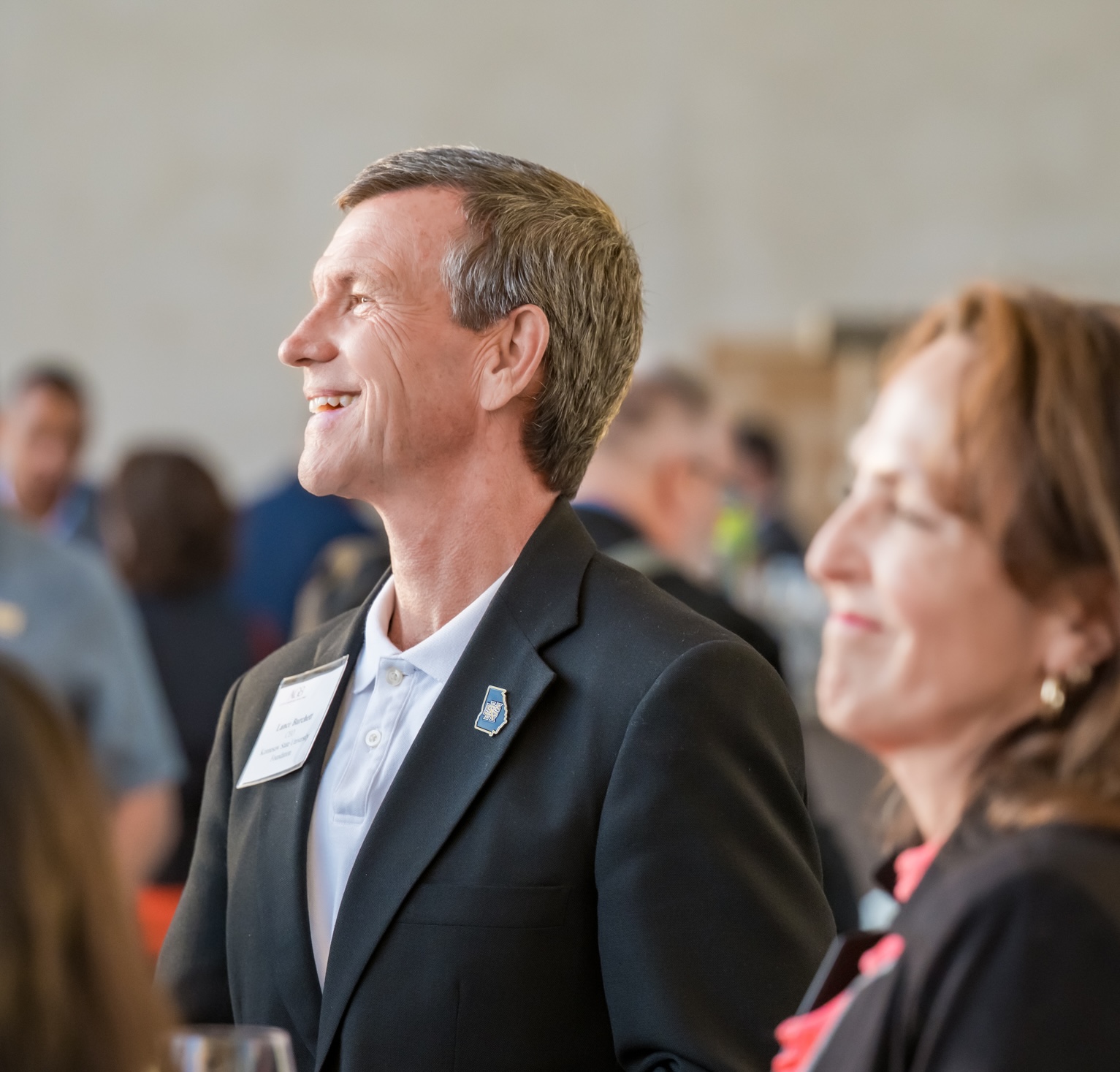 A foundation leader smiles while networking.